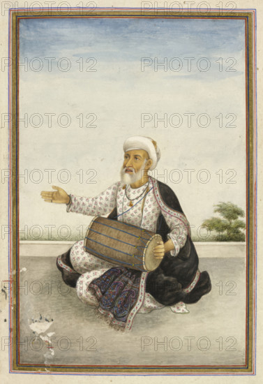 Kavval’, a sub-caste of the large Muslim caste of ‘Mirasis’ or singer/genealogists - A man beating a drum, 1825. From Tashrih Al Aqvam An Account Of Origins And Occupations Of Some Of The Sects Castes And Tribes Of India.