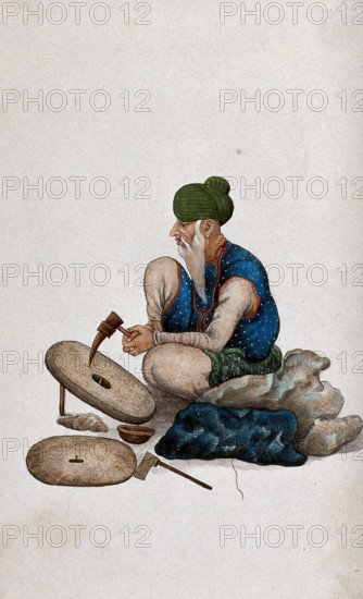 A man making grindstones, (between 1800 and 1899?). Creator: Unknown.