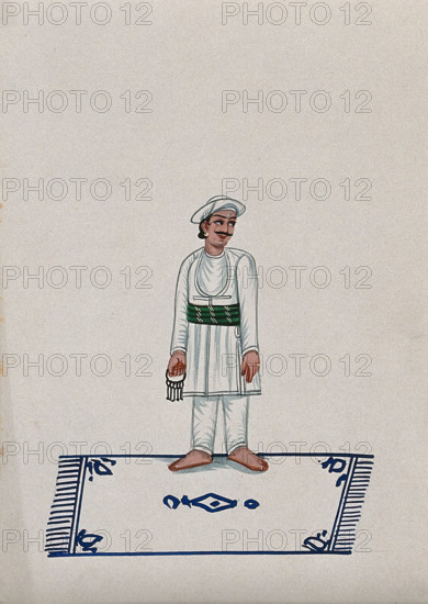 A servant standing on a carpet holding a bunch of keys, (between 1800 and 1899?). Creator: Unknown.