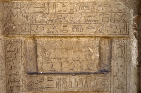 Hieroglyphic writing and deceased ofering food to the gods, Necropolis of Saqqara, Egypt, 2003. Creator: Unknown.