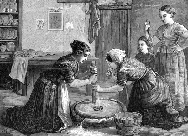 Women grinding corn in Ireland, 1874. Creator: Unknown.