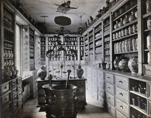 A seventeenth-century German apothecary's shop with ornate pharmacy jars..., c1900s. Creator: Christof Muller.