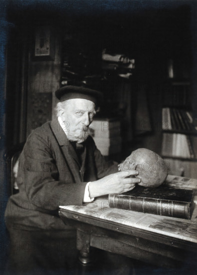 Adrien de Mortillet, holding a skull. Creator: Unknown.