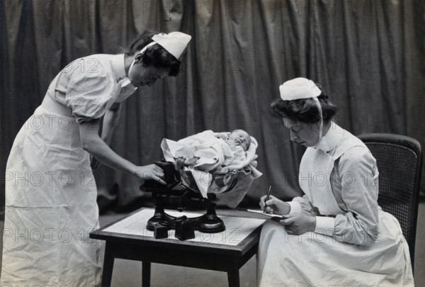 General Lying In Hospital, York Road, Lambeth: nurses weighing a baby, 1906 Creator: Unknown.