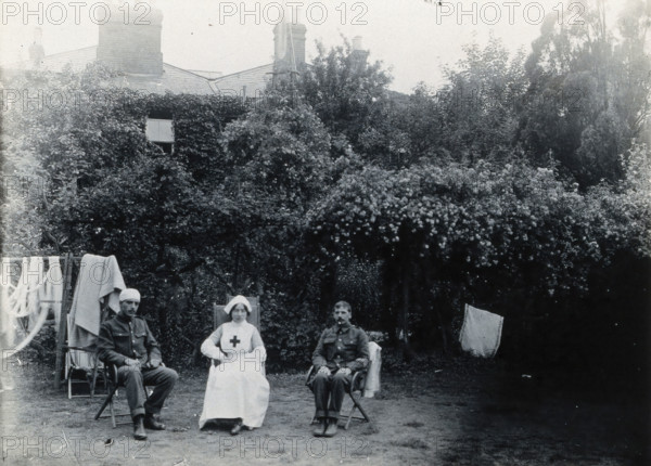 Holmleigh Auxiliary Military Hospital, Harrow: a nurse and two soldiers, one of whom has..., c1922. Creator: Unknown.
