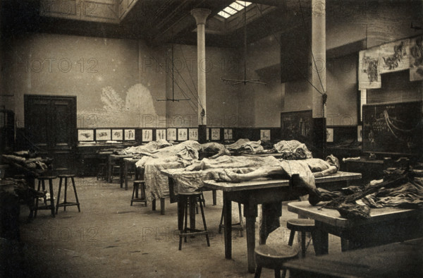 The interior of a dissecting room in Edinburgh, with half-covered cadavers on benches, 1889. Creator: Unknown.