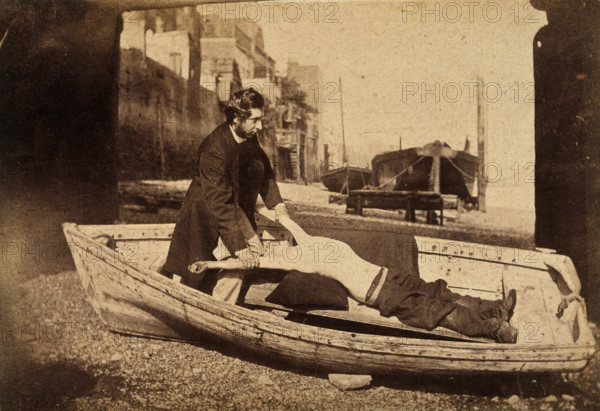 A man and a boy with bare torso in a rowing boat grounded on a beach..., c1860s. Creator: Unknown.