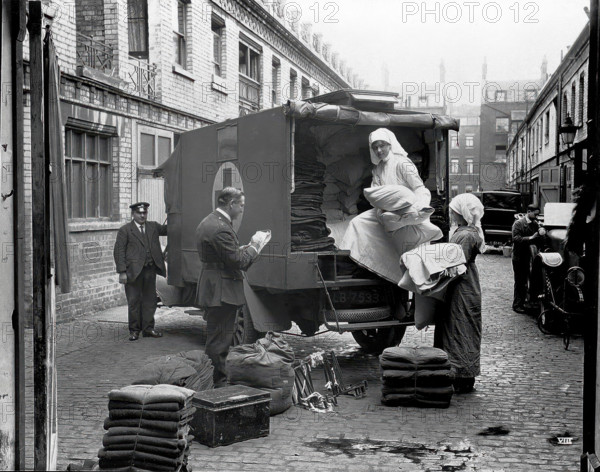 Ambulance Column depot, 9 Gower Street, London: loading up the blanket bus in Gower Mews, 1918. Creator: Unknown.