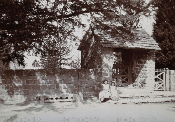 Mitchel Troy, Wales: lich-gate and stocks outside the church, c1890. Creator: Unknown.