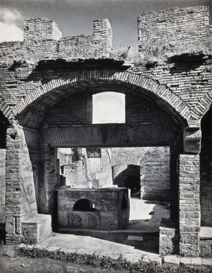 Partly ruined buildings in Ostia identified as a tavern or hot-food shop (thermopolium)..., 1920-9. Creator: Domenico Anderson.