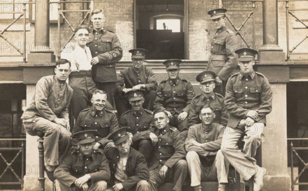 Soldiers posing for a group portrait outside a large building, c1910s. Creator: Unknown.