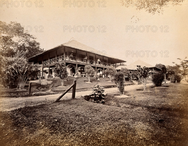 Singapore: a large bungalow for British officers with tropical plants in the garden, 1880. Creator: John Edmund Taylor.
