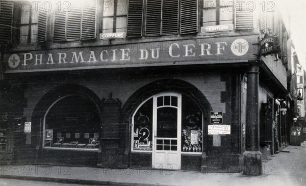 The front door of the Pharmacie du Cerf on the corner of the street, Strasbourg, c1900s.. Creator: Unknown.
