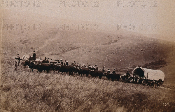 South Africa: landscape with people, a wagon and oxen in the foreground, 1896. Creator: Unknown.