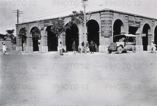 Two men in a car outside the Wellcome pharmaceutical depot in the Middle East, c1910.. Creator: Unknown.