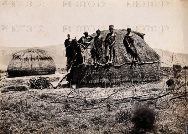 Africa: a group of African people standing on a kraal hut, between 1800 and 1899. Creator: Unknown.