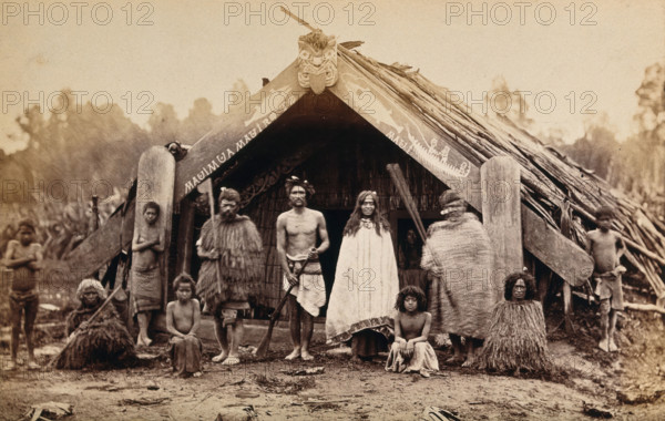 New Zealand: a group of Maori in front of a traditional building, 19th century. Creator: Unknown.