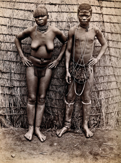 Africa: an African woman and man in front of a kraal hut, 19th century. Creator: Unknown.