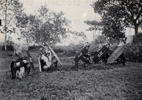 Sarawak: five Kenyah warriors in a warfare ritual, c1900. Creator: Unknown.