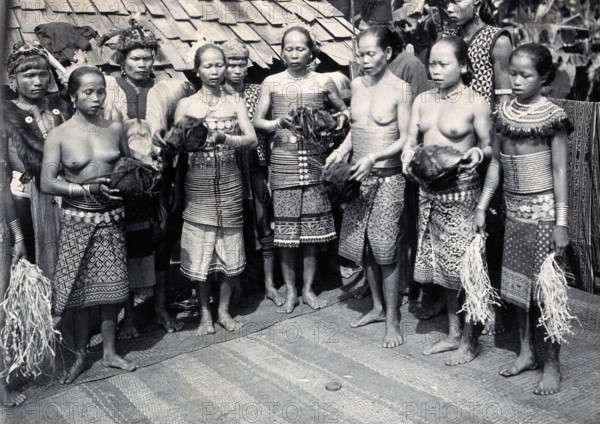 Sarawak: Sea Dayak men at a head feast, c1900. Creator: Unknown.