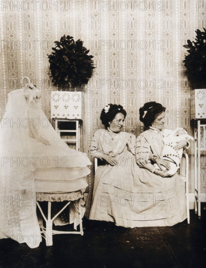 Josefa Blazek and Rosalia Blazek (Rosa Blazek), female conjoined twins, seated, holding...c1910. Creator: Unknown.