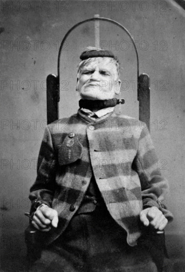 Wakefield Prison, Yorkshire: an elderly man, struggling against the restraint-chair in..., c1869. Creator: Unknown.