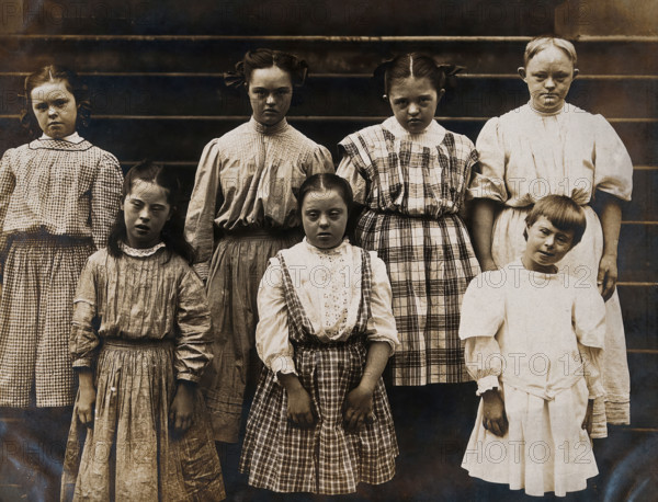 New York State Institute: a group of girls with Down's syndrome, standing on some steps, 1902. Creator: Unknown.