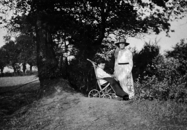 A physically disabled boy sitting in a wheelchair, c1910/1925. Creator: Unknown.