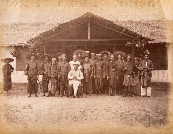 Malaya: Captain China surrounded by his Chinese and Malay followers, 1880. Creator: John Edmund Taylor.