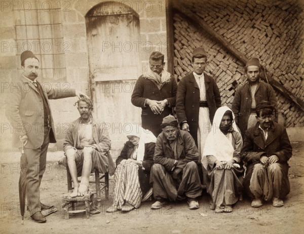 A group of people with leprosy in Jerusalem: a man in a striped suit..., c1890s. Creator: Unknown.