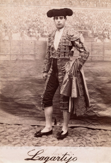A bullfighter, Rafael Molina Sanchez "Lagartijo", posing in front of a painted back..., c1870s. Creator: Unknown.