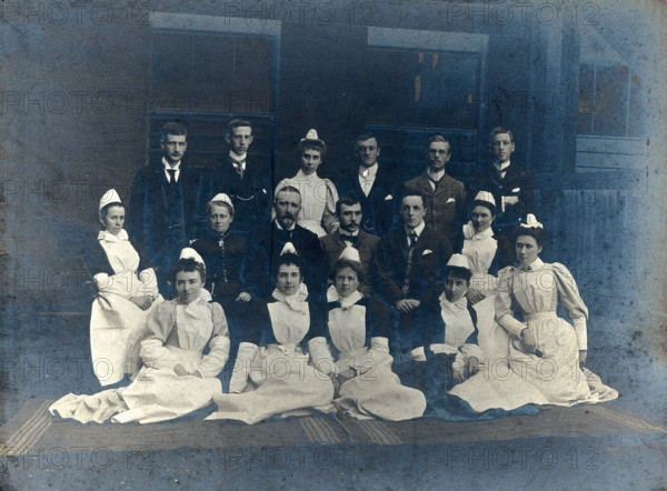 James Rutherford Morison with his staff: seven men and nine women, c1900. Creator: Unknown.