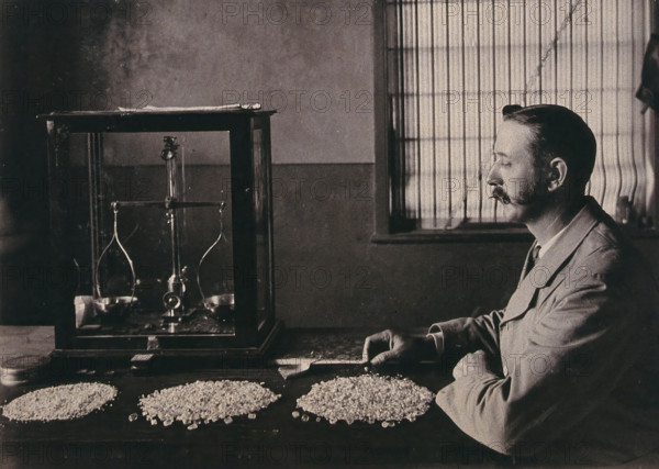 South Africa: an employee of De Beers counting the diamonds mined that day, 1896. Creator: Unknown.