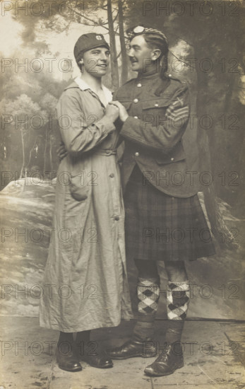 Two soldiers playing in a military concert party embrace: one is in drag and the ..., [1910-1919]. Creator: Unknown.