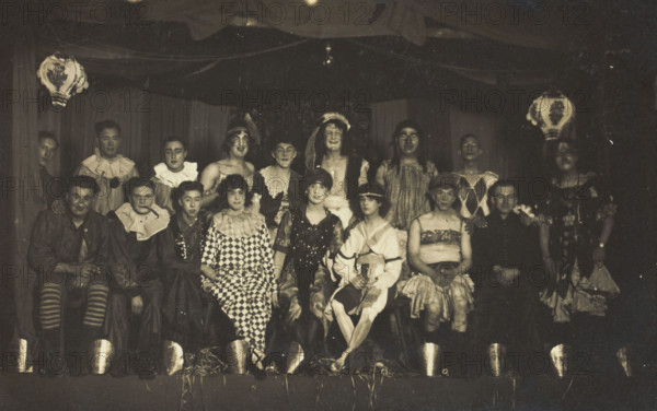 An ensemble cast of British soldiers, some in drag, pose on stage, 1919. Creator: Unknown.