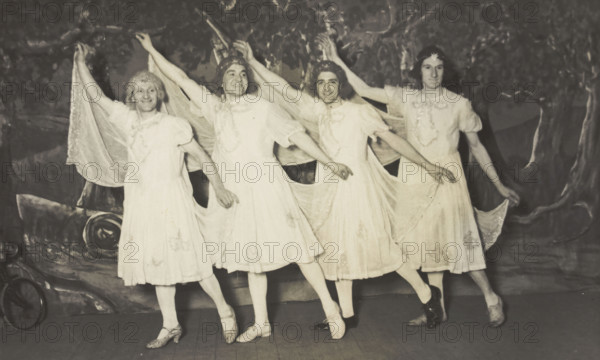 Amateur actors in drag, wearing white dresses and dancing on stage, [between 1910 and 1919?]. Creator: Unknown.