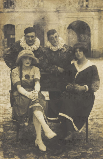 Members of 'The Stars' concert party, two soldiers in drag and two as pierrots, pose around..., 1919 Creator: Unknown.