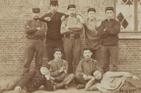 Belgian soldiers posing for a group portrait in a casual manner, 1908. Creator: Unknown.