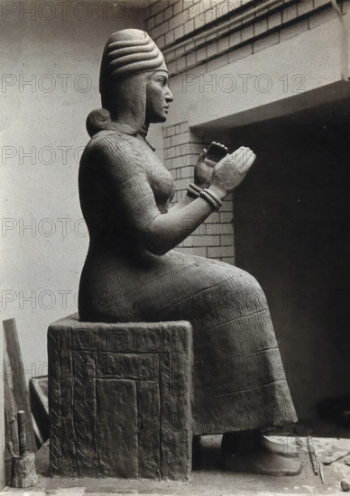 A sculpture of Gula, Mesopotamian deity of healing, with a dog at her side, c1900. Creator: Unknown.