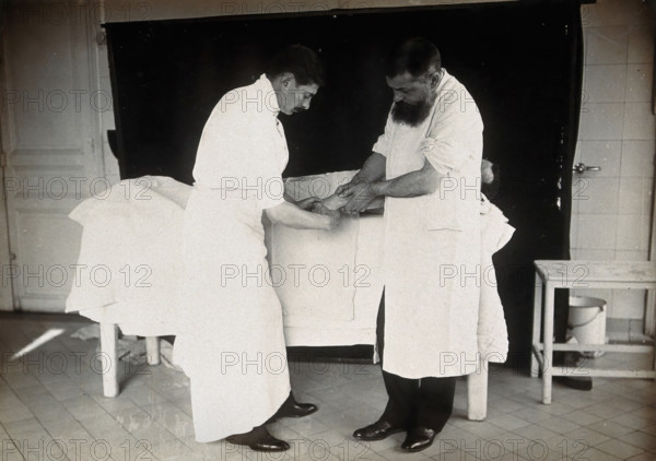 F Lejars demonstrating operation techniques, c1900s. Creator: E Guillot.