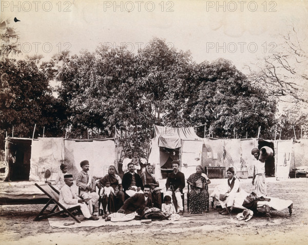An affluent family forced to leave their home due to plague in their neighbourhood sitting...1896/7. Creator: Unknown.