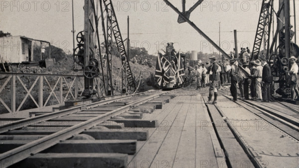 Zimbabwe: people and a flag-covered train at the opening of Victoria Bridge, 1905. Creator: J Lomas.