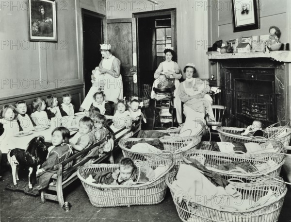 30 Albury Street; Nursey at dinner time, Children in Baskets, 1911. Creator: Unknown.