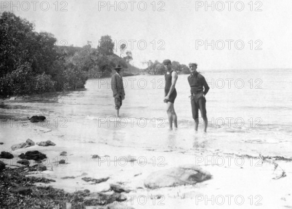 Men in swimming costumes at the water's edge, possibly at the mouth of the Tweed River, 1910. Creator: Robert Augustus Henry L'Estrange.