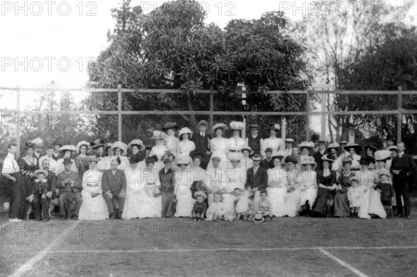Possibly City Electric Light company employees and their families on a tennis court, 1903. Creator: Robert Augustus Henry L'Estrange.