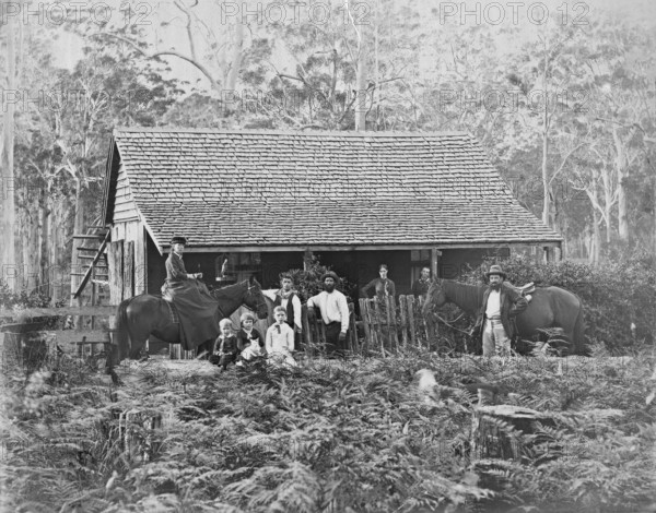 Australian wooden slab hut with large unknown family outside, c1900s. Creator: Robert Augustus Henry L'Estrange.