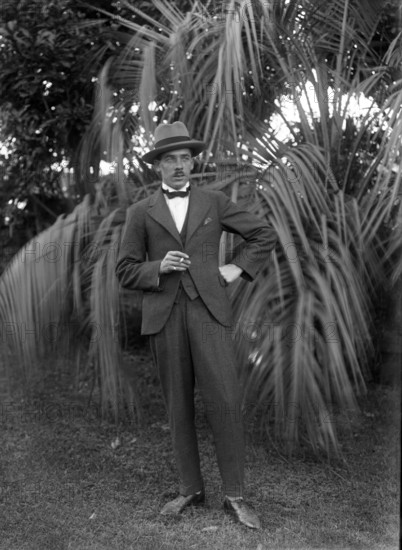 Photos and life story of John Henderson L'Estrange (1864-1913) standing and William Manderville Elli Creator: Robert Augustus Henry L'Estrange.