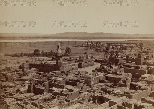 Village of Edfu, View Taken from the Pylon of the Temple, late 19th century. Creator: Henri Bechard.