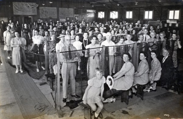 Camouflage net making, Kelvin Grove Drill Hall (now Z 10), Brisbane, 1941. Creator: Isabel Bain.