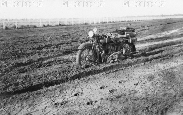 Motorbike in mud, near Dalby, Queensland, 1930. Creator: Jack Bain.